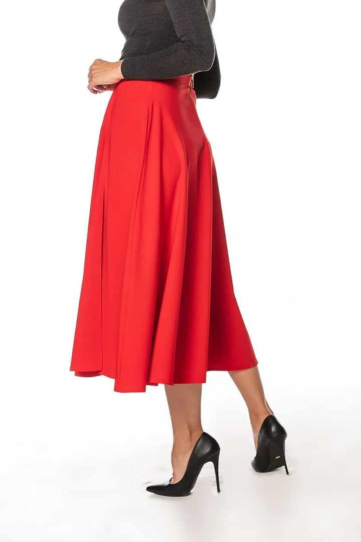 Red midi skirt with pleats and black pointed-toe heels on a white background.