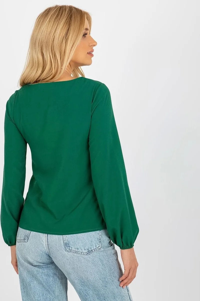 Emerald green long-sleeve top with gathered cuffs, shown from the back on a model wearing light-wash denim jeans.