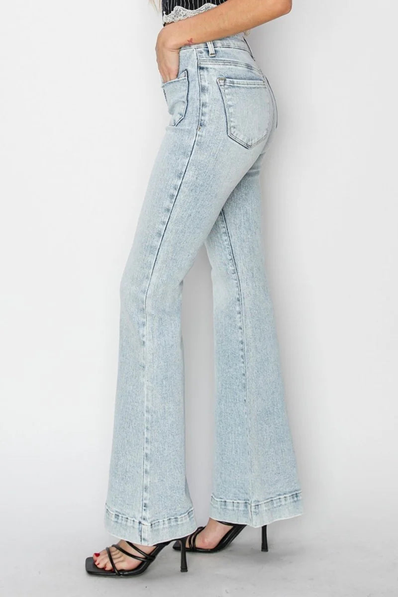 Light wash distressed denim flare jeans with a high rise and frayed hem.