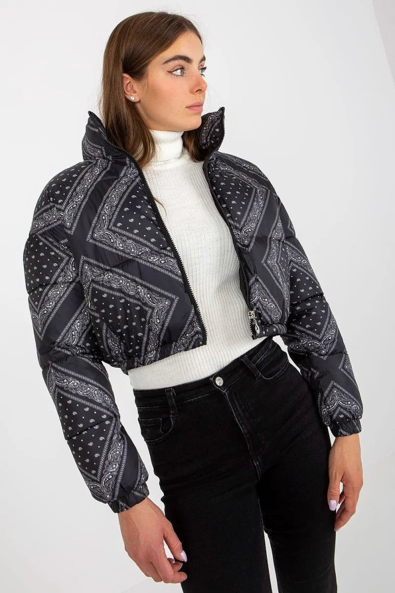 Black cropped puffer jacket with a white paisley bandana print, worn by a model with black jeans.