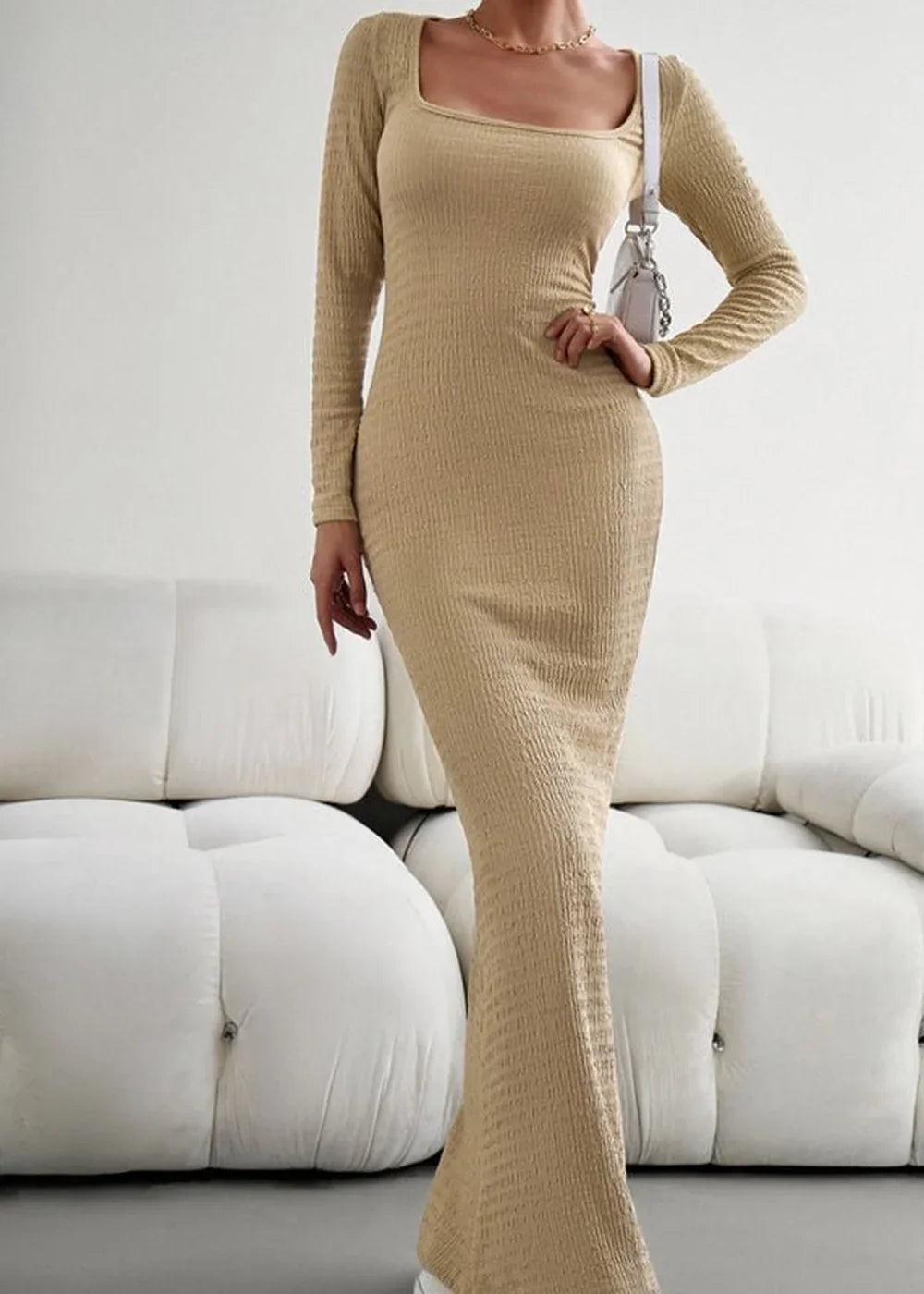 Beige ribbed knit maxi dress with a square neckline and long sleeves, shown on a model.