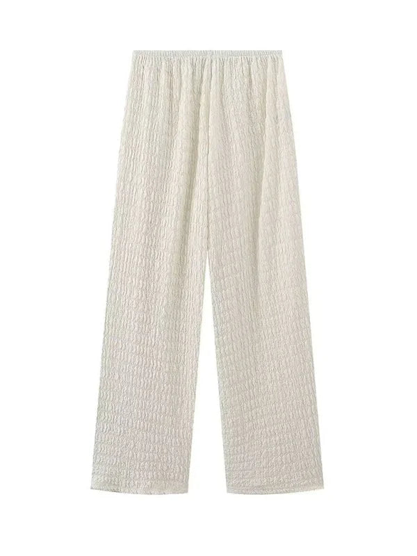 Cream textured wide-leg pants with an elastic waistband.