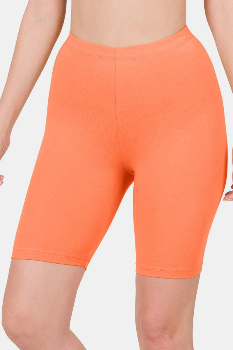 Orange biker shorts with a smooth, stretchy texture and a regular fit.