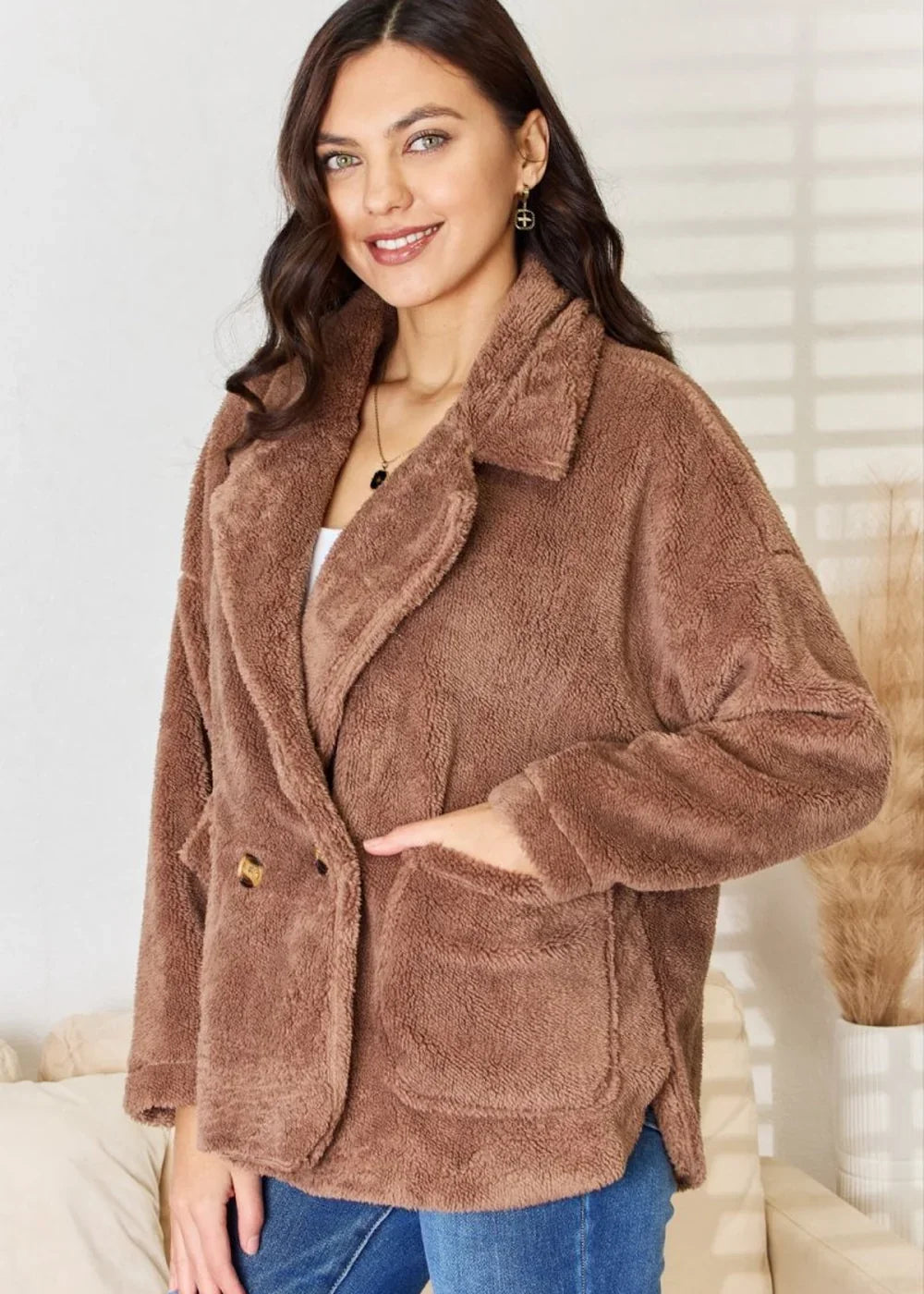 Soft brown teddy bear jacket with a double-breasted closure and patch pockets, worn by a model.