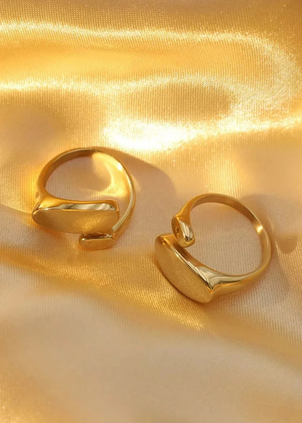 Golden, satin fabric with two shiny gold rings, one on the left and one on the right.