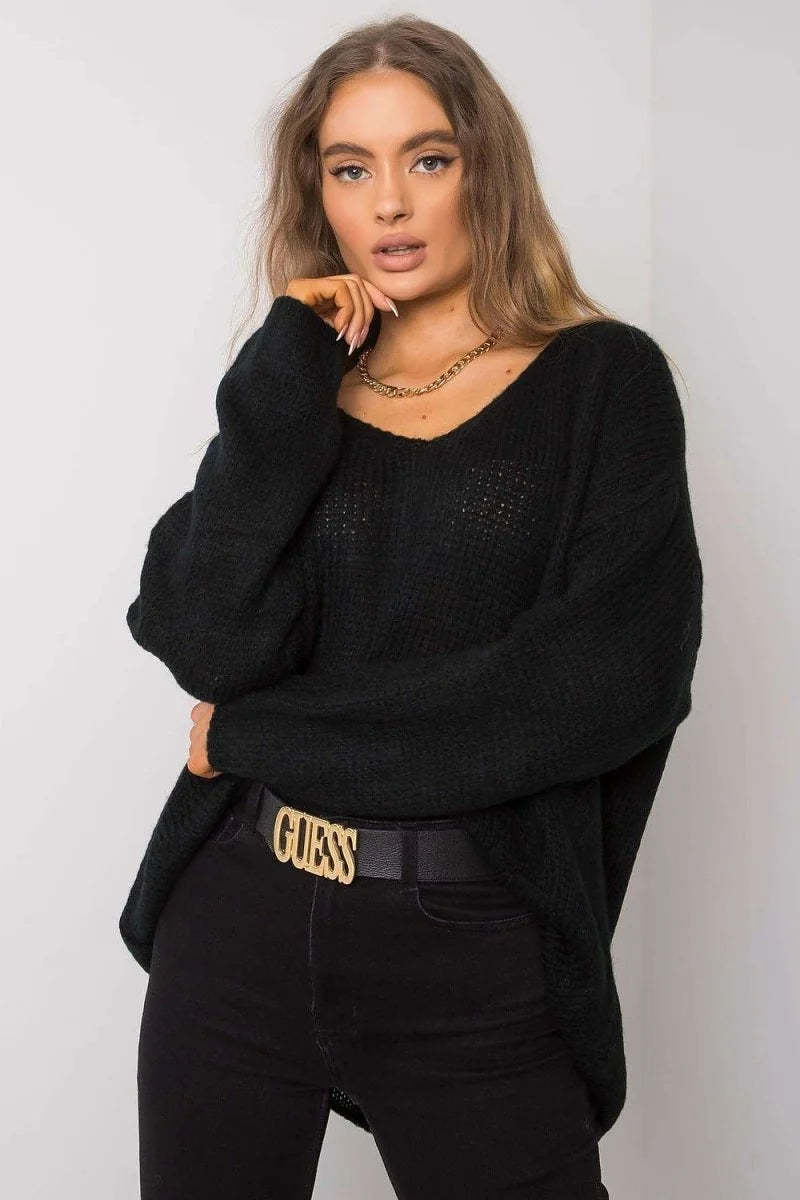 Black v-neck knit sweater with gold chain necklace and black jeans with gold buckle belt on model.