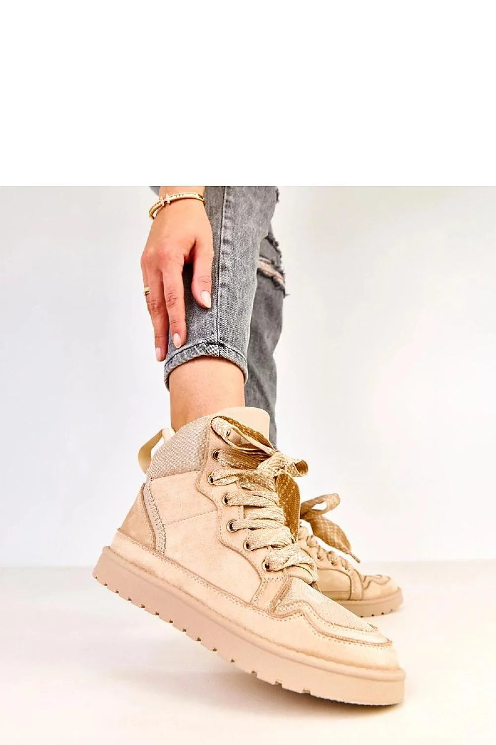 Model wearing beige women's sport shoes