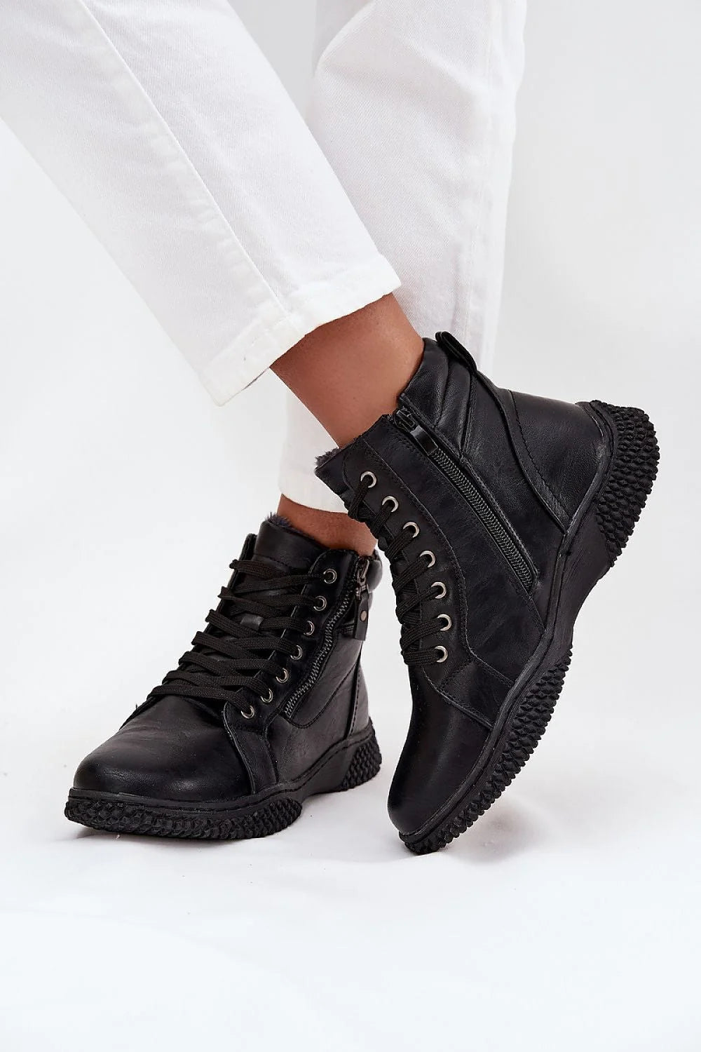 Black leather combat boots with lacing and side zippers, featuring a textured sole.
