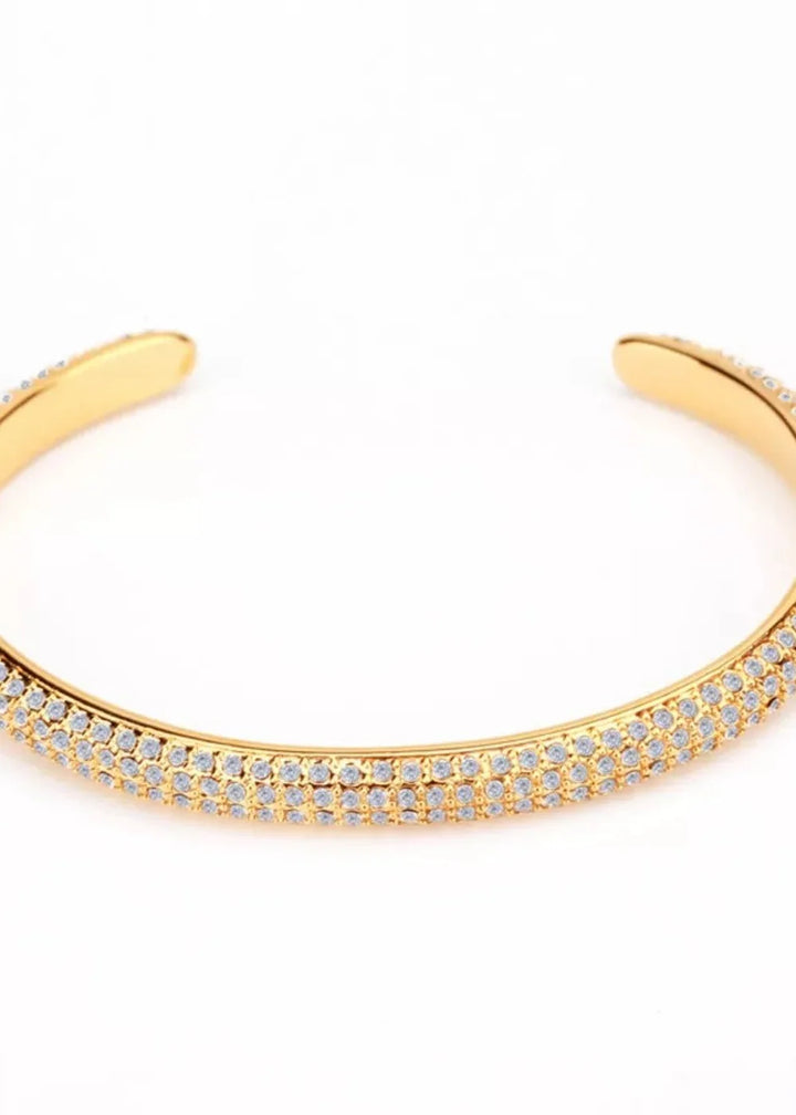 Gold-plated cuff bracelet with two rows of sparkling white cubic zirconia stones.