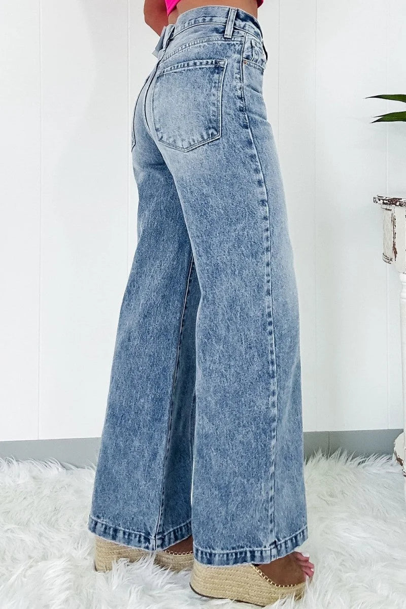 Light blue acid wash wide-leg jeans showing a slightly stretchy fit on model.