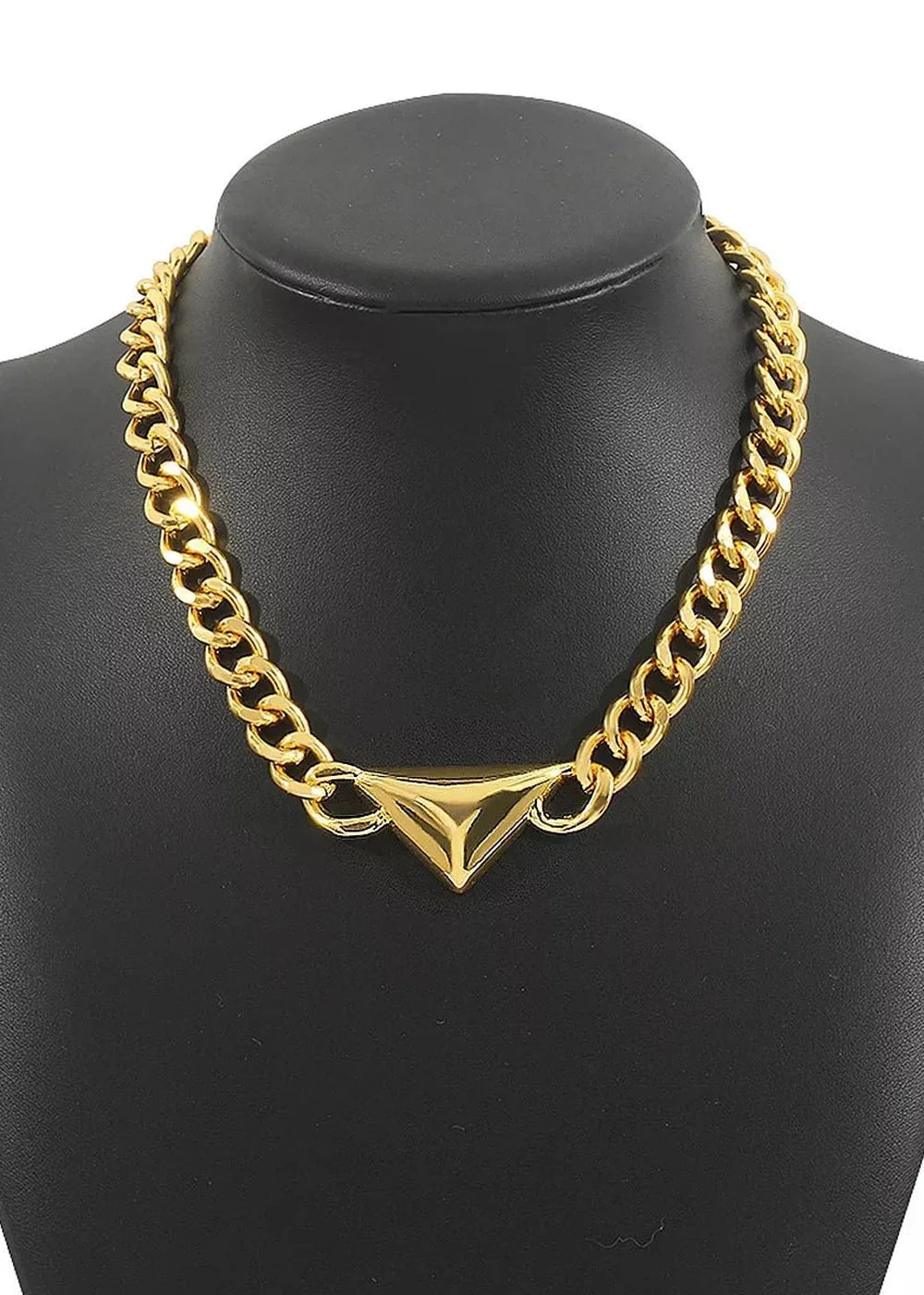 Gold-plated chain necklace with a geometric triangular pendant on a black display bust.