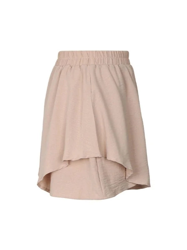 Light beige high-waisted shorts with a ruffled, asymmetrical hem and subtle textured fabric.