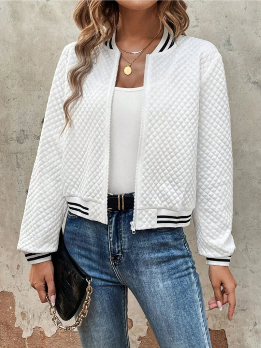 White quilted bomber jacket with black striped ribbed cuffs and collar, worn by a model.