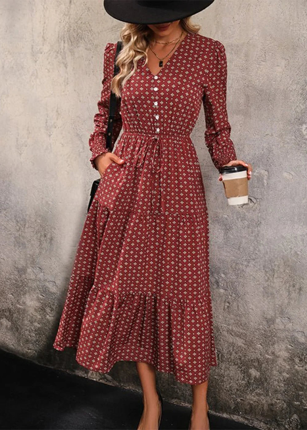 Red midi dress with a geometric print, V-neck, button front, cinched waist, and tiered ruffled hem.