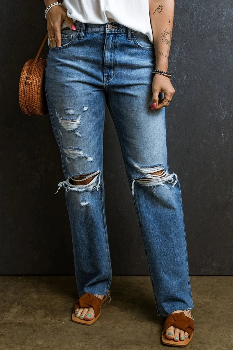 Model wearing distressed raw hem jeans