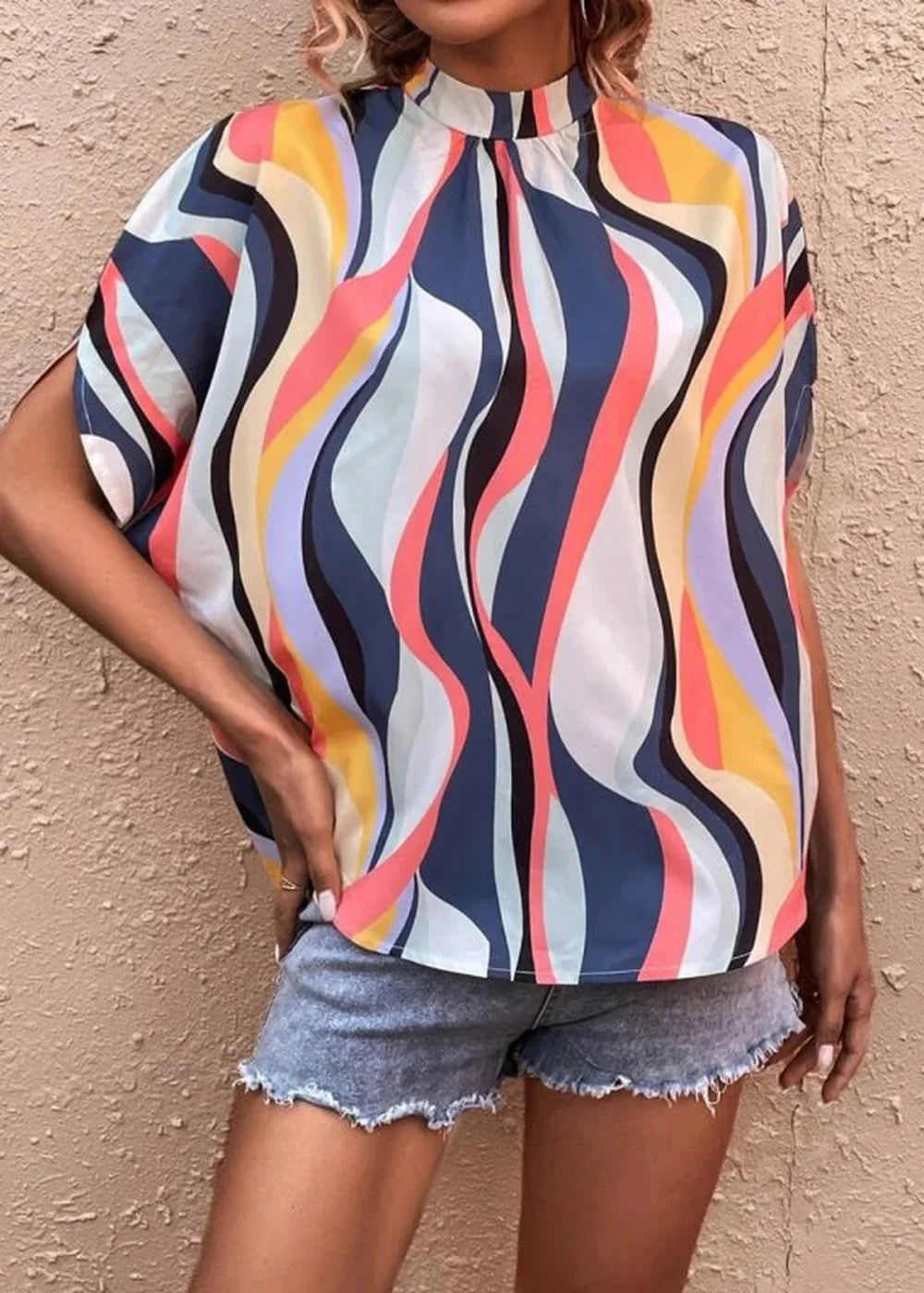 Model wearing a casual printed dolman sleeve top