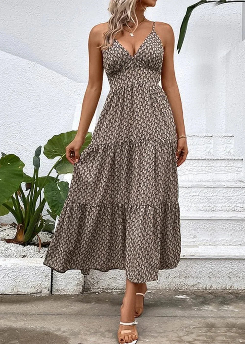 Khaki tiered maxi dress with a geometric print and spaghetti straps, worn by a model.