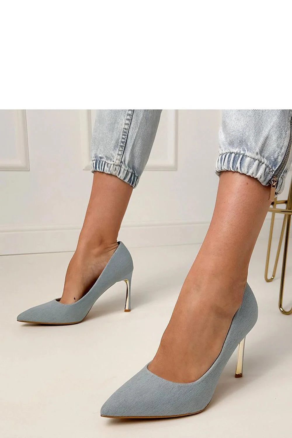 Light blue denim pointed-toe pumps with gold stiletto heels.
