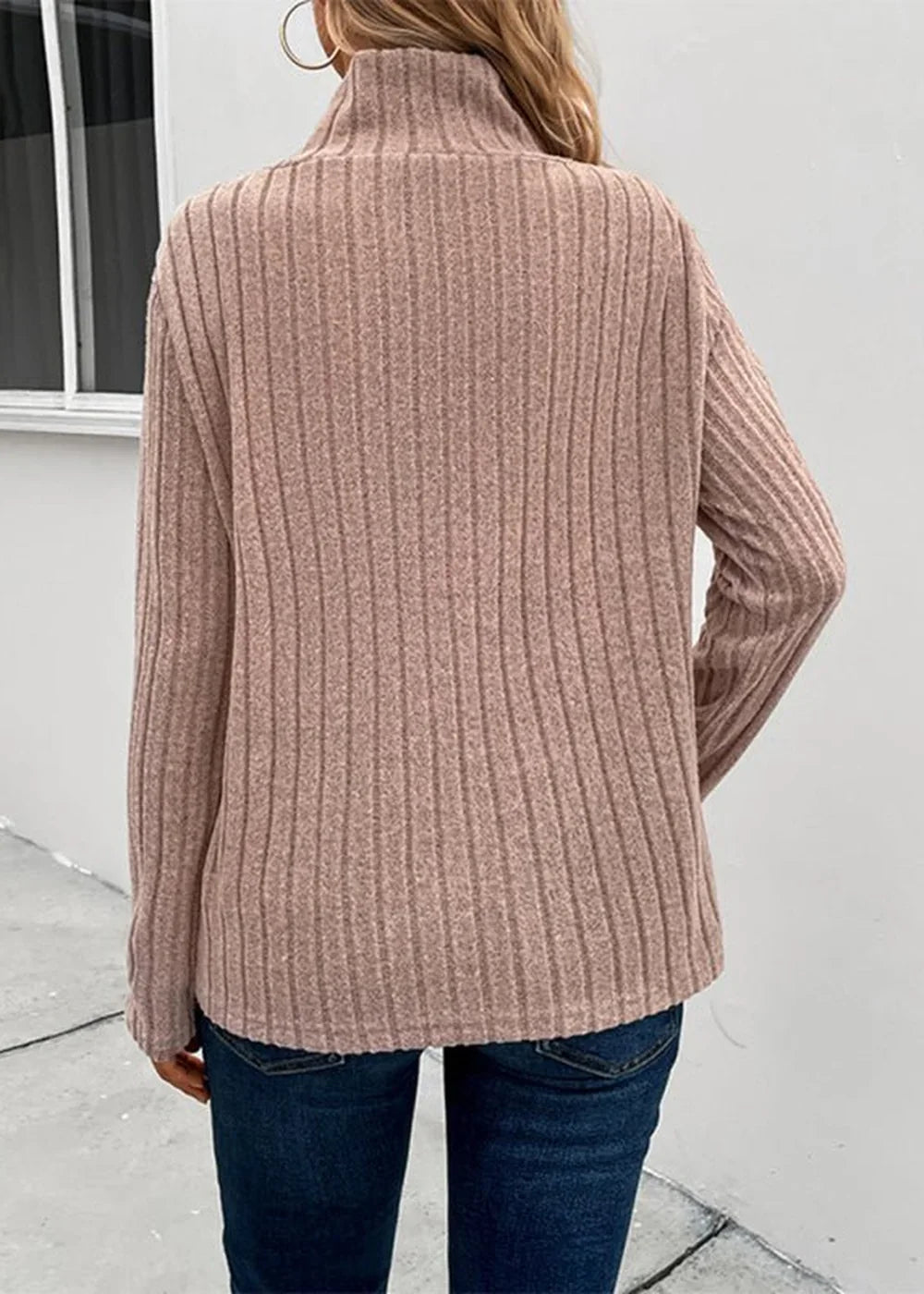 Dusty rose ribbed turtleneck sweater with long sleeves, shown from the back on a model.
