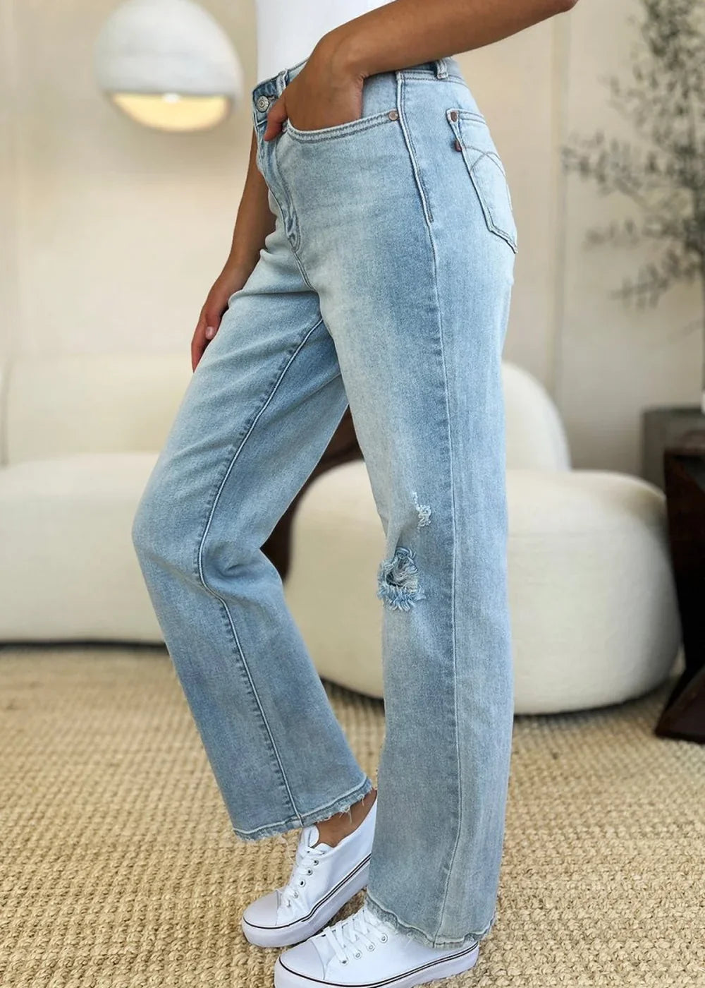 Model wearing high waist straight leg jeans