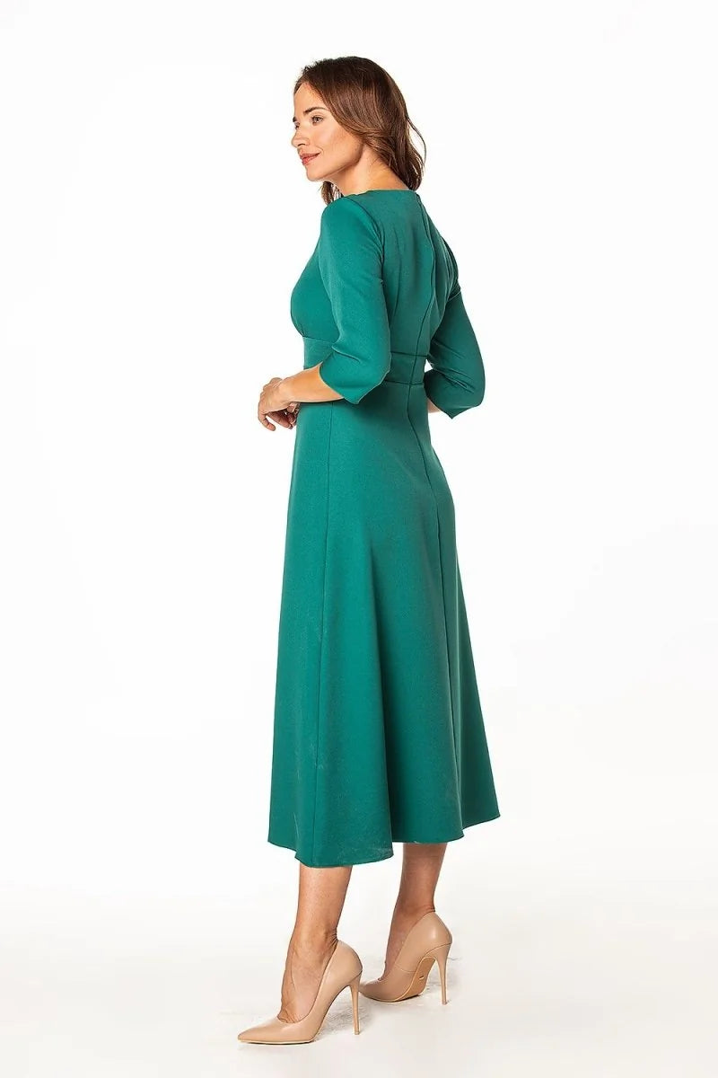 Teal midi dress with 3/4 sleeves and nude stiletto heels, shown from the side.