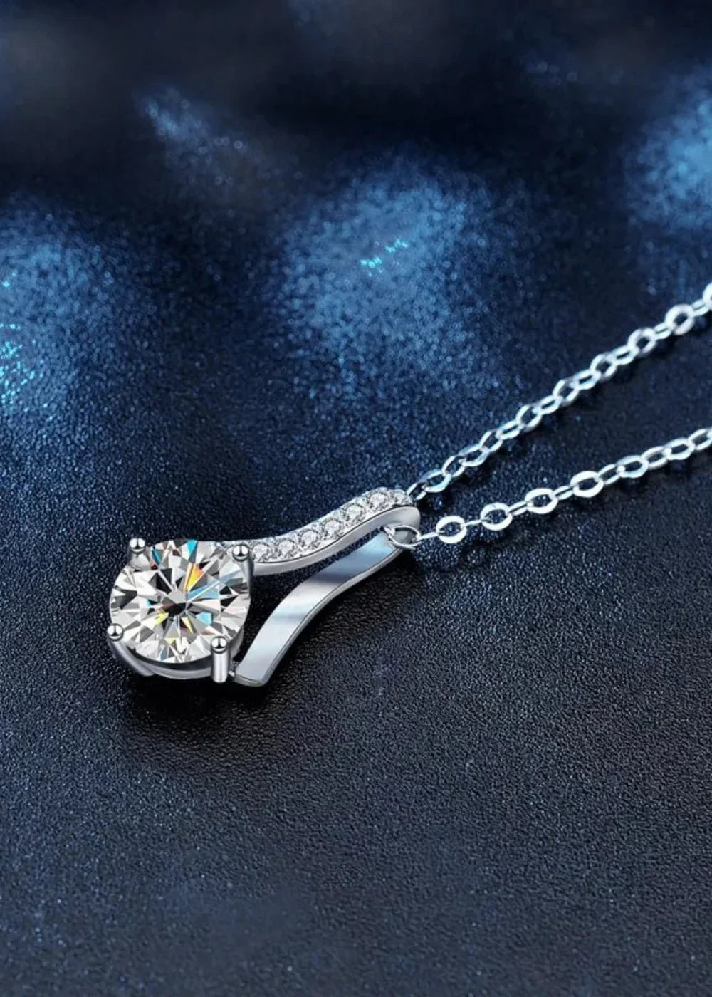 Close-up of a platinum-plated sterling silver necklace with a sparkling moissanite diamond.