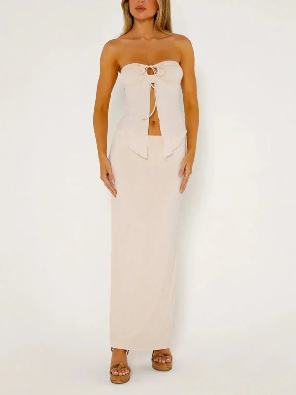 Beige strapless tie-front top and maxi skirt set on a model.