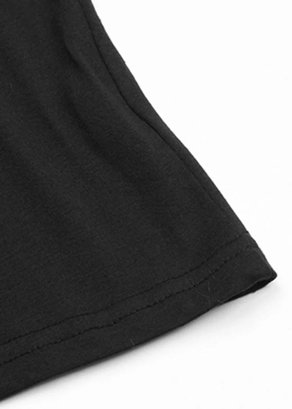 Close-up of black polyester-spandex fabric with double-stitched hem detail.