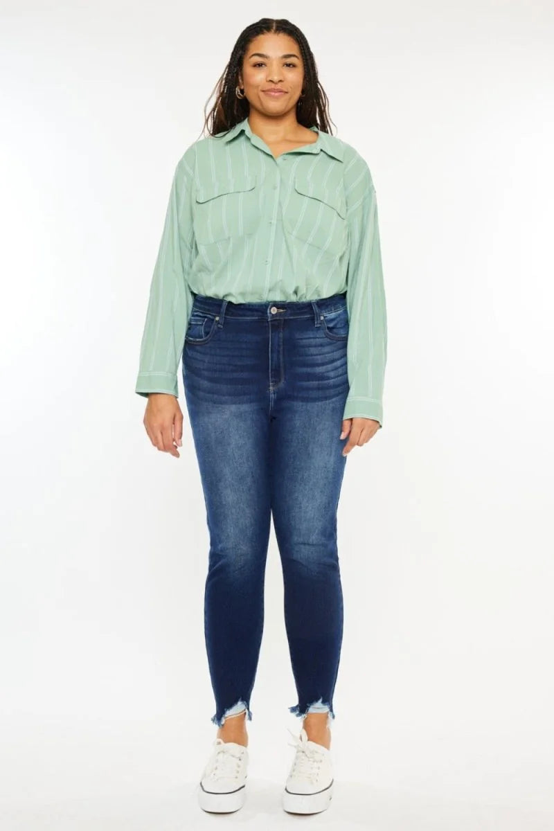 Dark wash distressed denim jeans with frayed hem and a slightly stretchy fit on a model.