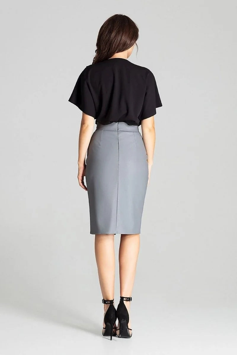 Back view of a woman wearing a grey pencil skirt and black heels.