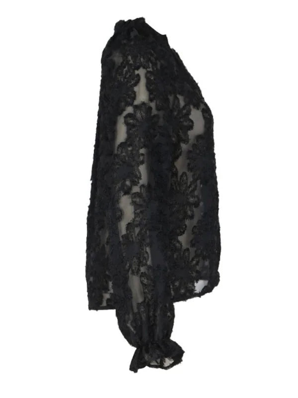 Black sheer lace top with floral pattern and ruffled cuffs, side view.