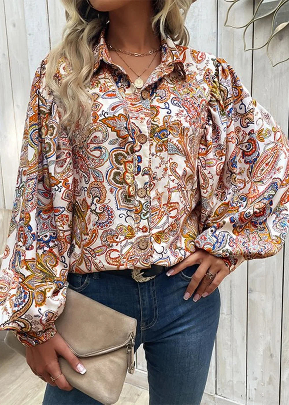 Loose fit, white blouse with colorful paisley print and voluminous sleeves.