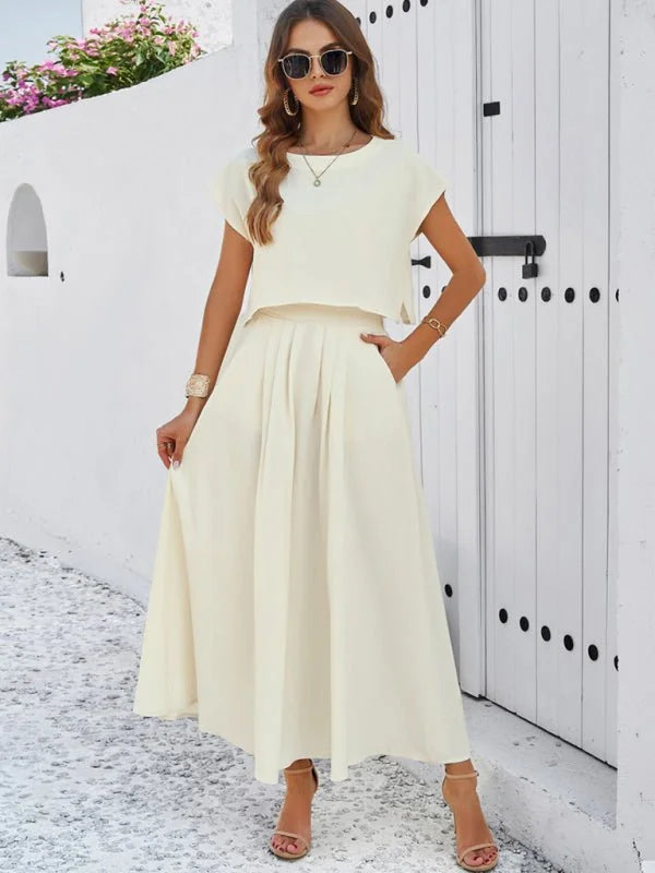 Cream linen-blend two-piece set with a cropped top and flowy A-line skirt on a model.