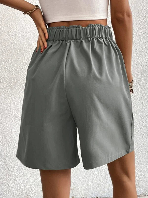 Gray wide-leg shorts with elasticated waist and side slits, shown from the back.