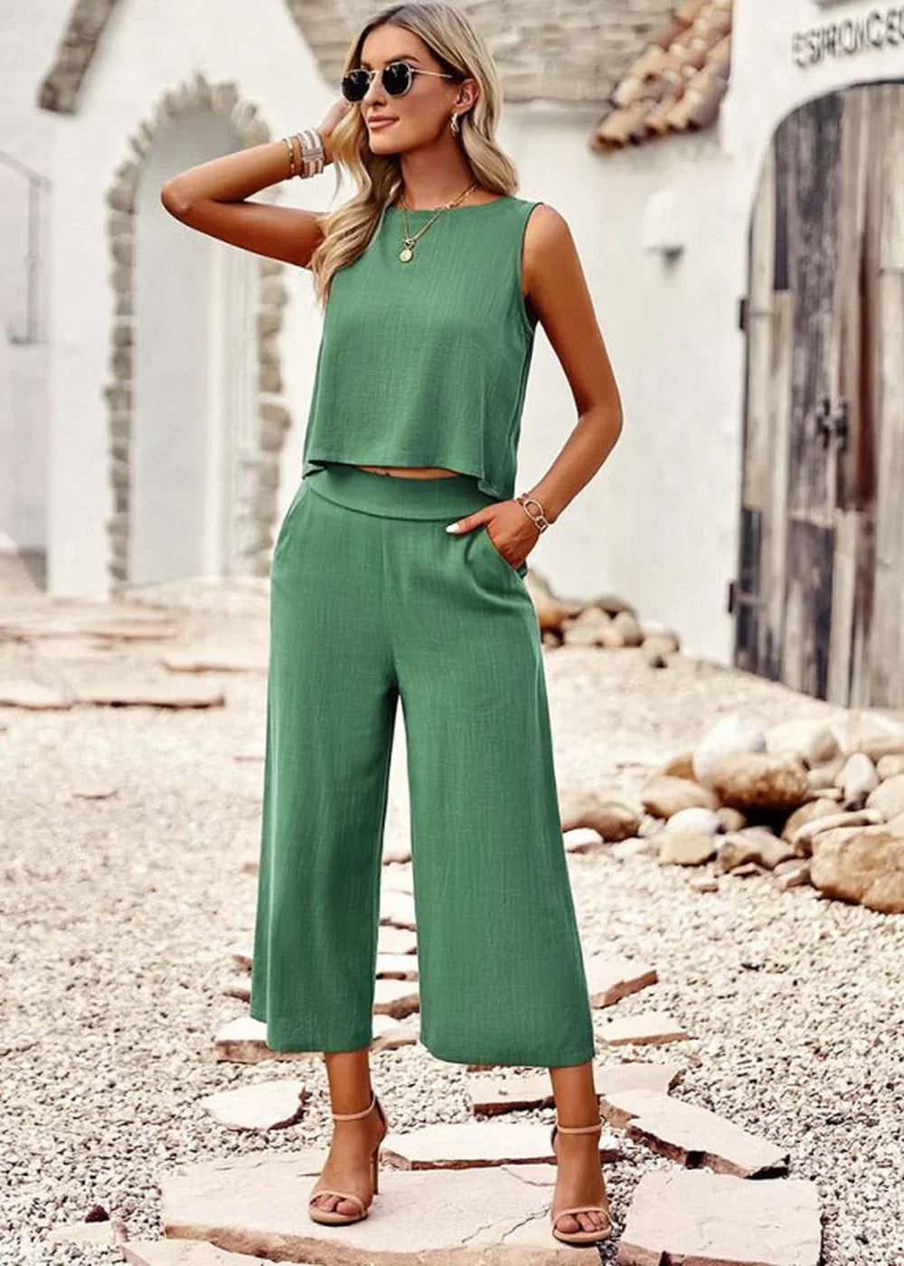 Green linen-blend crop top and wide-leg culotte pants set with gold jewelry, on model.