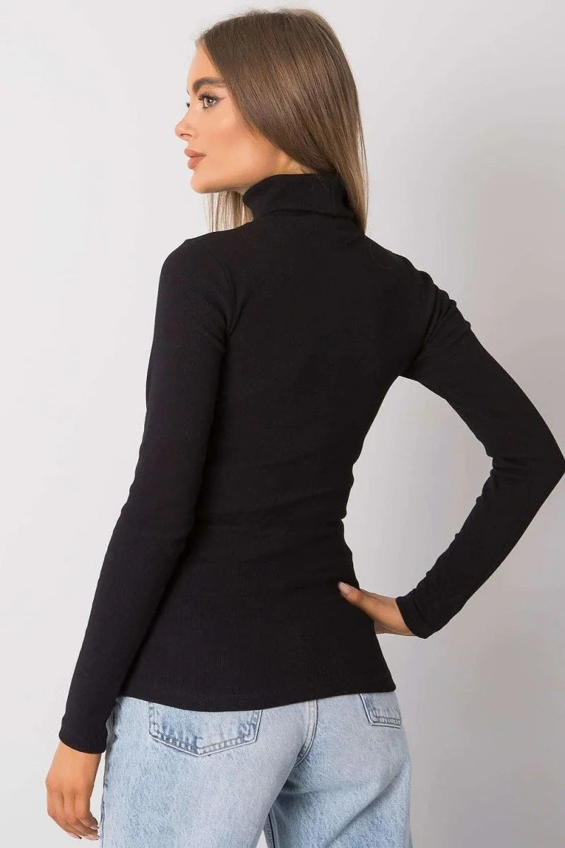 Black ribbed turtleneck long-sleeve top with a fitted cut, worn by a model.