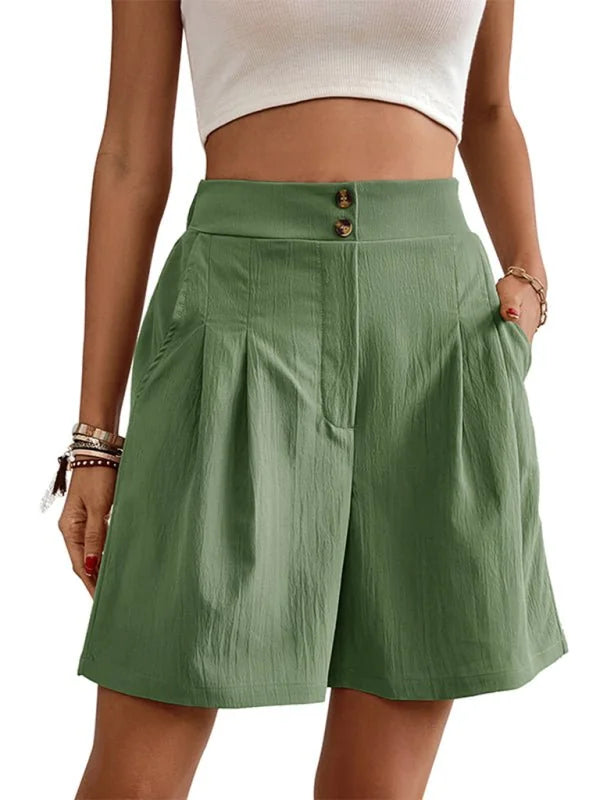 Green linen-blend shorts with a high waist and button closure, on a model.