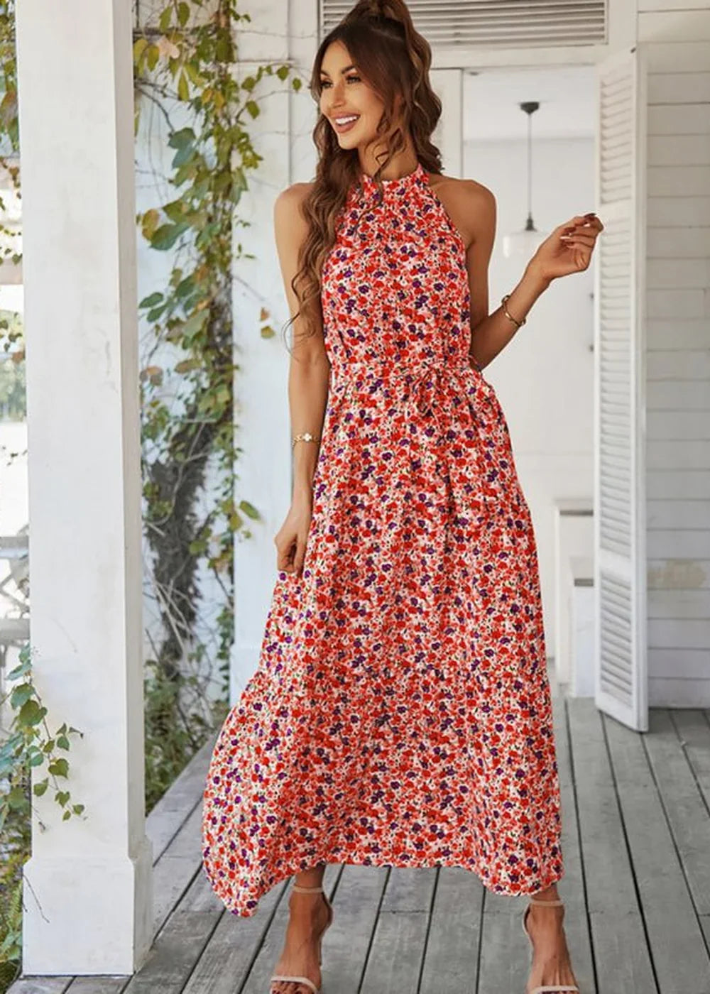 Red floral print halter neck maxi dress with a tie waist and subtle ruffles.