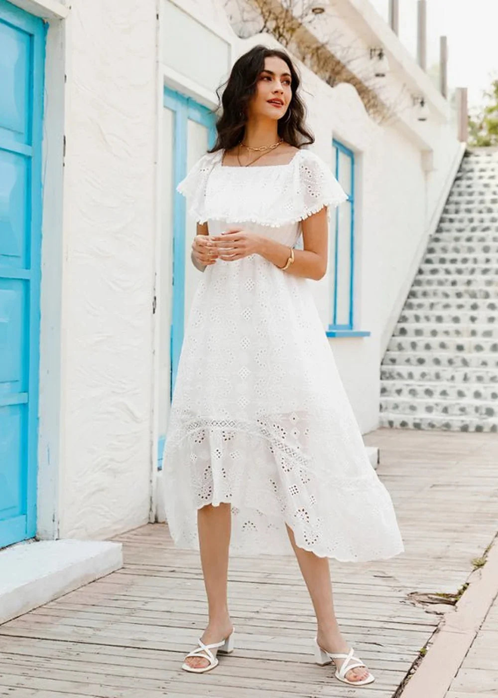White cotton midi dress with eyelet details, off-the-shoulder neckline, and ruffled trim.