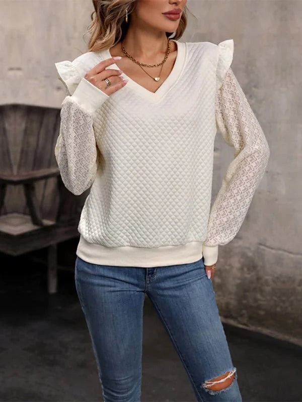 Cream quilted v-neck sweater with ruffled shoulders and lace sleeves.