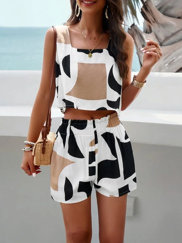 Woman wearing a cropped tank top and shorts set with a black, white, and tan abstract print.