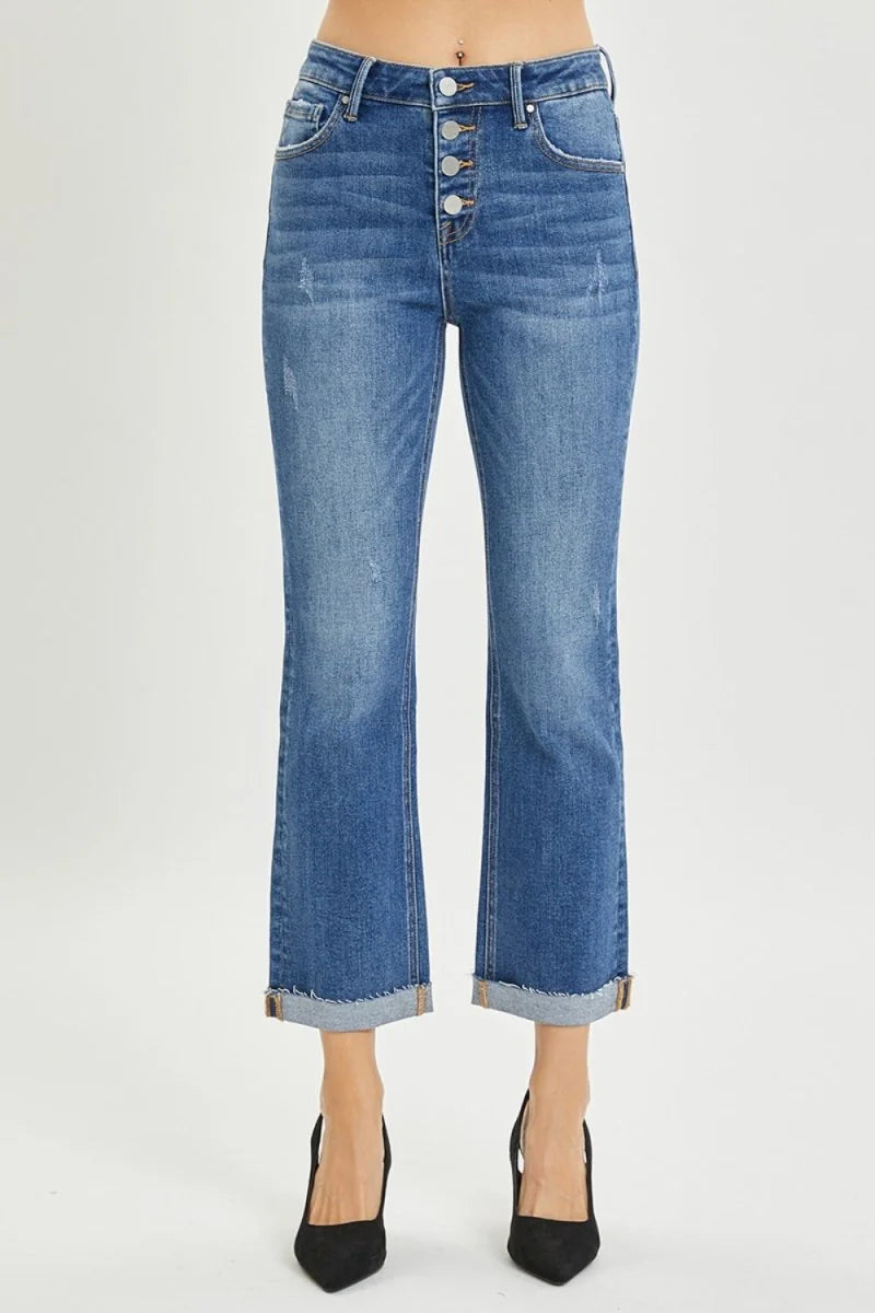 Medium wash distressed denim jeans with button fly and cuffed hem.