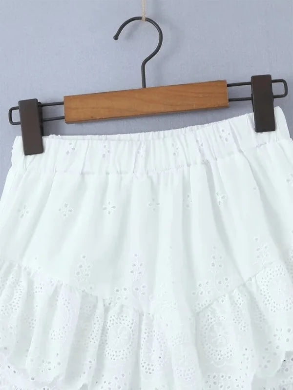White cotton skirt with eyelet embroidery and ruffled hem detail.