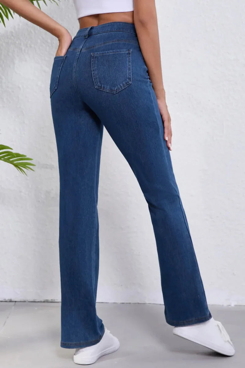 Dark blue denim jeans with a regular fit and flared leg, shown from the back on a model.