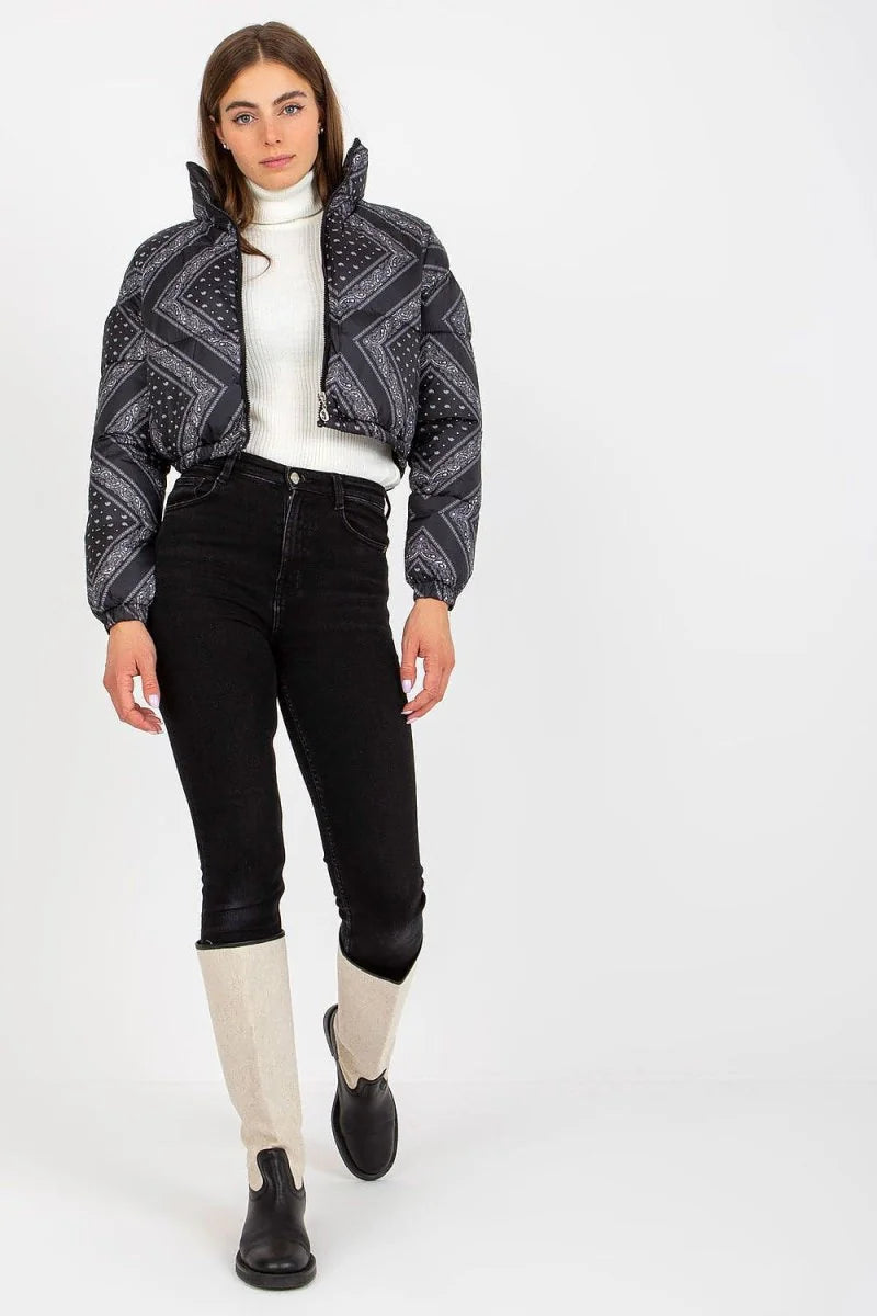 Black puffer jacket with a bandana-inspired print, worn by a model with black jeans and two-tone boots.