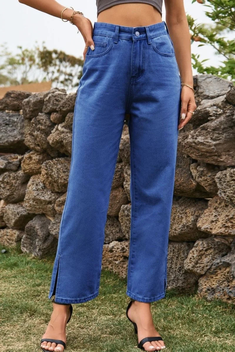 Blue denim pants with a relaxed fit and a subtle slit at the ankle.