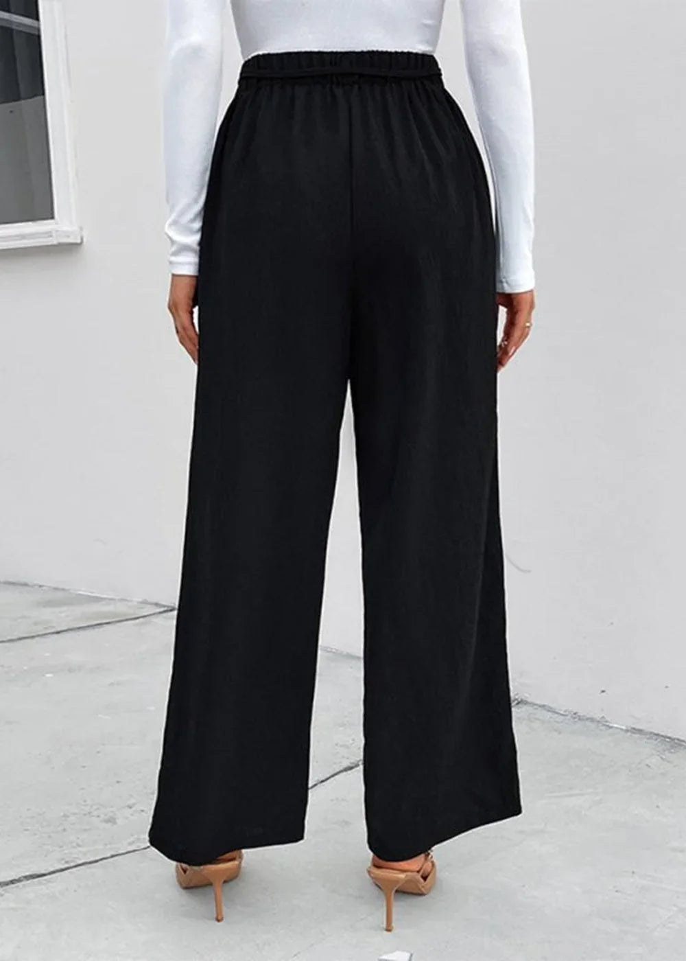 Black wide-leg polyester pants with elastic waistband, shown from the back.