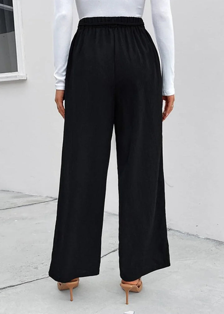Black wide-leg polyester pants with elastic waistband, shown from the back.