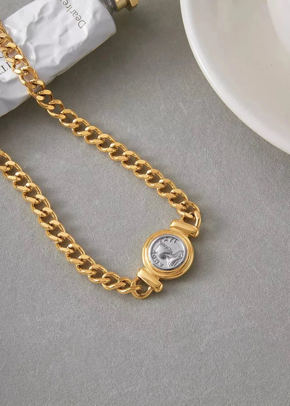 Gold-plated cuban link chain necklace with a silver-plated coin pendant featuring a horse relief.