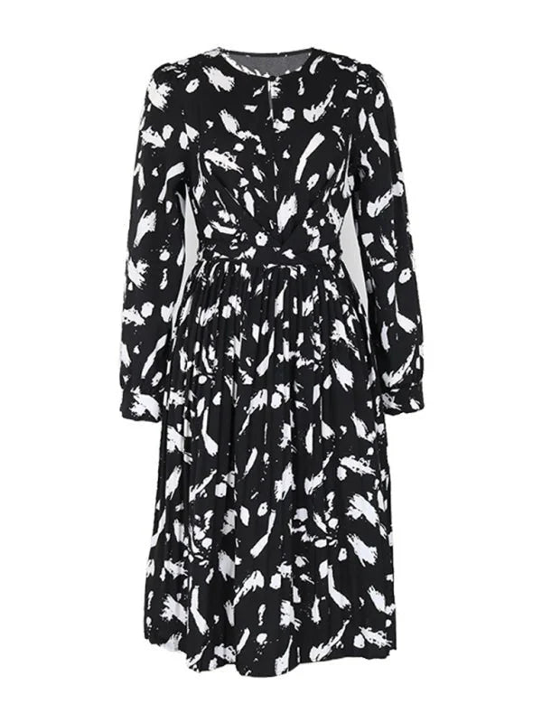 Black and white abstract print midi dress with long sleeves and pleated skirt.